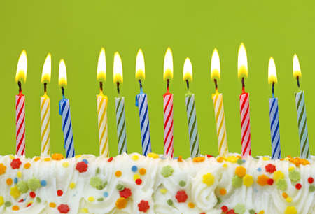  Colorful birthday candles on green background の写真素材
