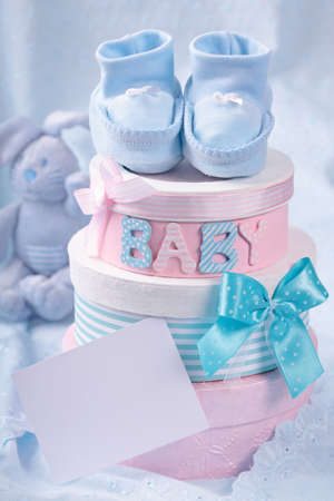 Little baby booties and gift boxes with blank noteの写真素材