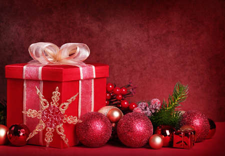 Christmas gift box on red backgroundの写真素材