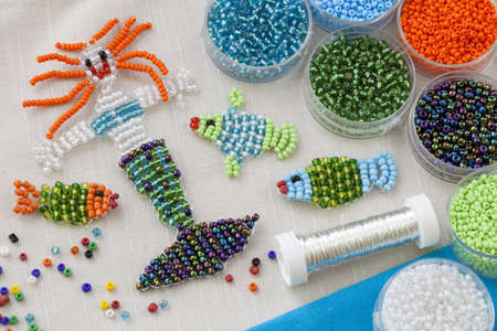 Beaded fishes and mermaid and colorful beadsの写真素材