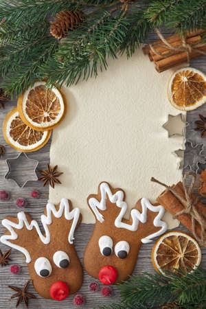Blank note and christmas cakes on wooden backgroundの写真素材