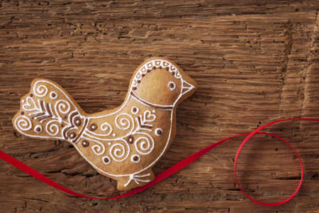 Gingerbread bird cookie on wooden backgroundの写真素材