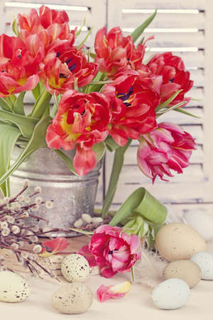 Tulip flowers and easter eggs on wooden backgroundの写真素材