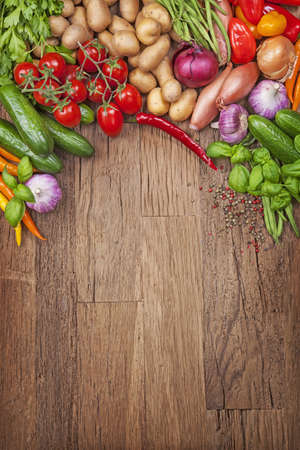Assortment of fresh vegetables on a wooden backgroundの写真素材
