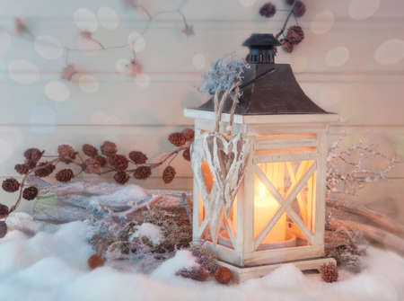 Burning lantern and christmas decoration on white backgroundの写真素材
