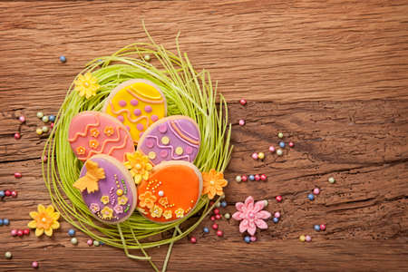 Colorful easter cookies on a wooden background