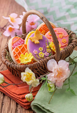 Colorful easter cookies in a basketの写真素材