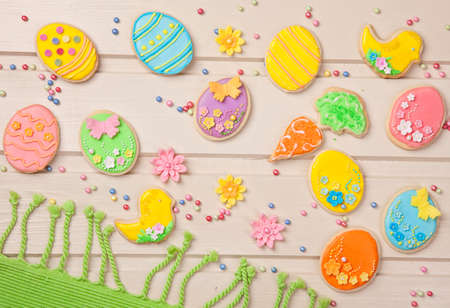 Colorful easter cookies on a wooden background