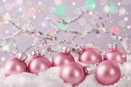 Pastel pink colored ornaments on snowの写真素材
