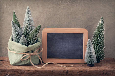 Retro christmas decoration and wooden empty blackboardの写真素材