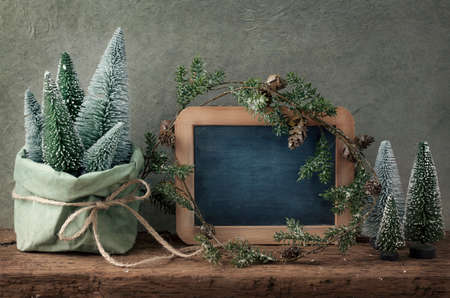 Retro christmas decoration and wooden empty blackboardの写真素材