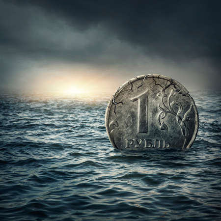 Ruble coin sinking in water.Russian economic crisis conceptの写真素材