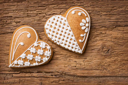 Gingerbread heart cookies on a wooden brown backgroundの写真素材