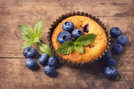 Blueberry muffins in old metal cupcake holderの写真素材