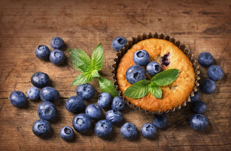 Blueberry muffins in old metal cupcake holderの写真素材