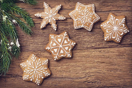 Gingerbread christmas cookies on a wooden brown backgroundの写真素材