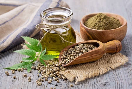 Hemp oil n a glass jar and hemp seedsの写真素材