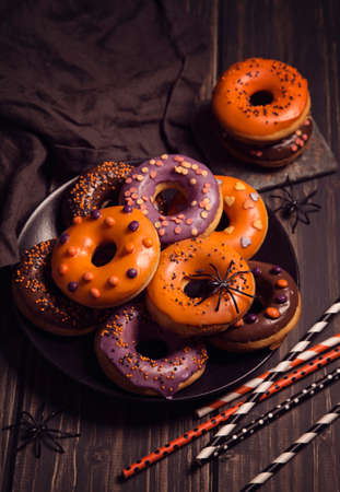 Halloween donuts on a dark wooden backgroundの写真素材