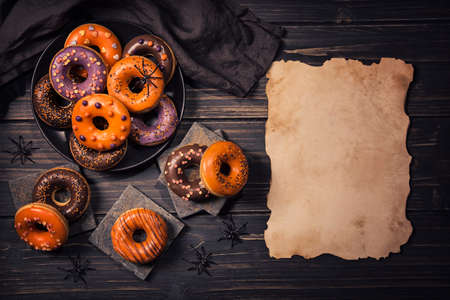 Halloween donuts on a dark wooden backgroundの写真素材