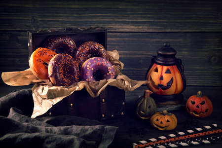 Halloween donuts on a dark wooden backgroundの写真素材