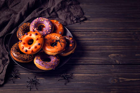 Halloweeen donuts on a dark wooden backgroundの写真素材