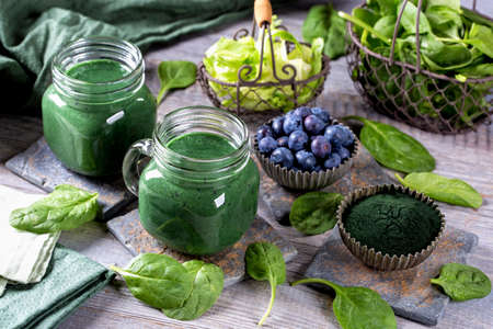 Green smoothie with spirulina,spinach and blueberriesの写真素材