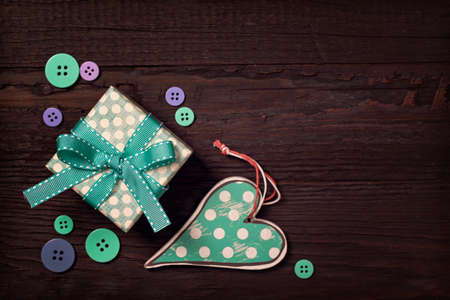 Gift box and hearts on a brown backgroundの写真素材
