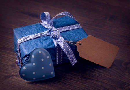 Blue gift box on a wooden backgroundの写真素材
