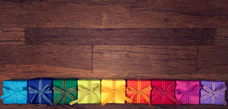 Colorful gift boxes above the wooden backgroundの写真素材