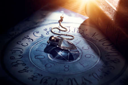 Foretelling the future with crystal pendulumの写真素材