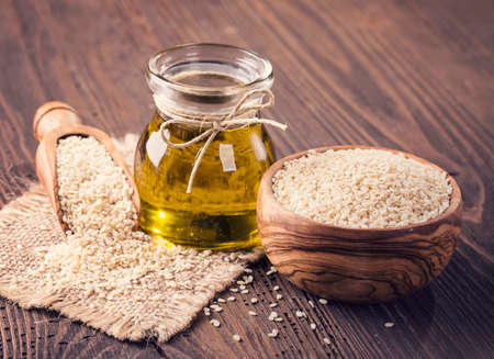 Sesame oil in glass and seedsの写真素材