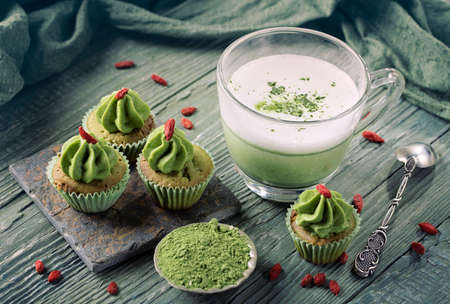 Matcha cup cakes with goji berry and matcha latteの写真素材