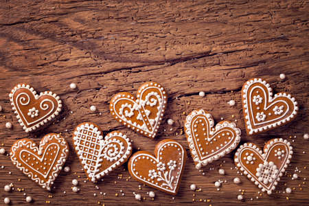 Gingerbread heart cookies on a wooden brown backgroundの写真素材