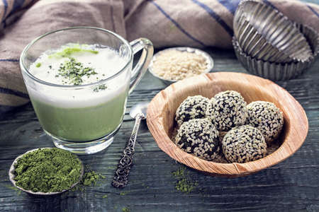 Matcha energy balls from dates and almonds and matcha green tea latteの写真素材