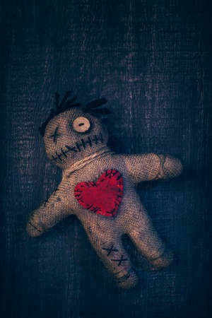 Voodoo doll with pins stuck into itの写真素材