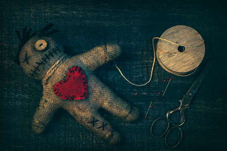 Voodoo doll with pins stuck into itの写真素材