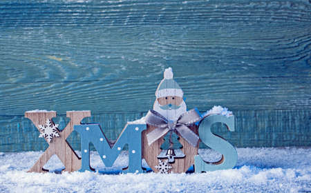 Letters Xmas and christmas decoration on a blurry sparkle backgroundの写真素材