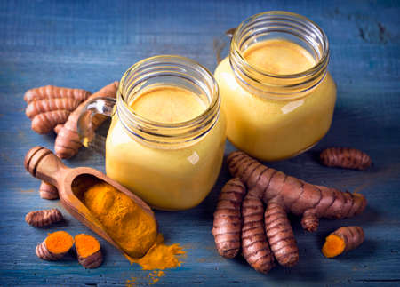 Turmeric Latte and fresh turmeric rootsの写真素材