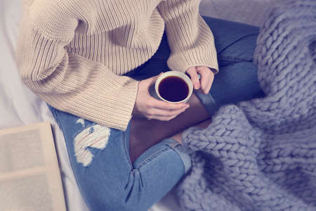 Young girl with a book and a cup of coffeeの写真素材
