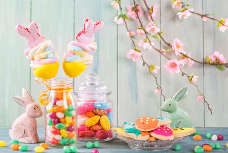 Colorful sweets on a green wooden background