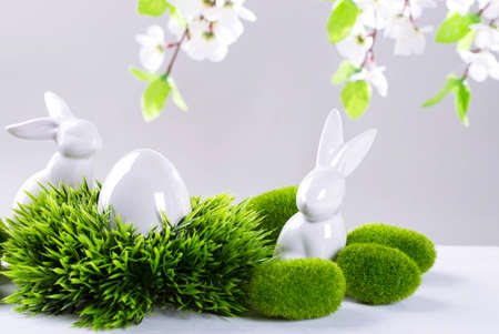 Ceramic easter rabbits and egg on a grey backgroundの写真素材