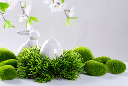 Ceramic easter rabbits and egg on a grey backgroundの写真素材