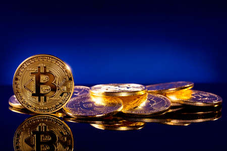Gold bitcoins on a blue background