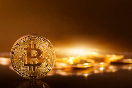 Gold bitcoins on a yellow backgroundの写真素材