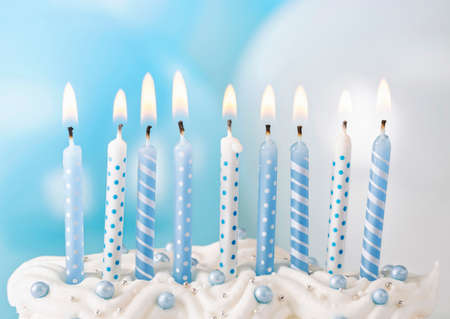 Pastel blue candles in a rowの写真素材