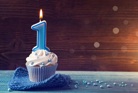 Cupcake with a blue candle for first birthdayの写真素材