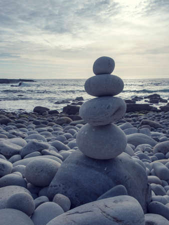 Pyramid of pebbles on the sea frontの写真素材