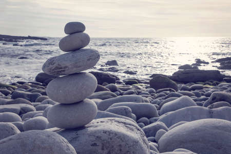 Pyramid of pebbles on the sea frontの写真素材
