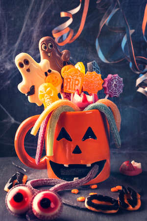 Pumpkin mug with sweets for halloween partyの写真素材