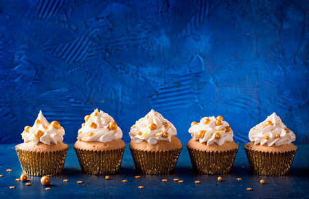 Christmas cupcakes on a wooden backgroundの写真素材